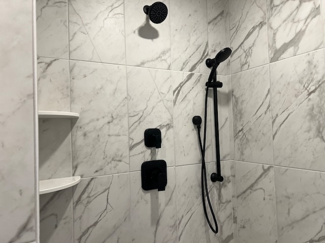 bathroom with a tile shower