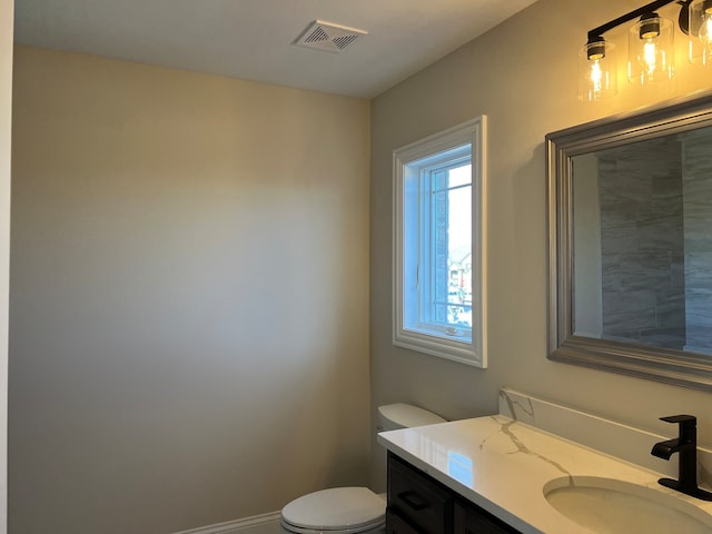 bathroom with toilet and vanity