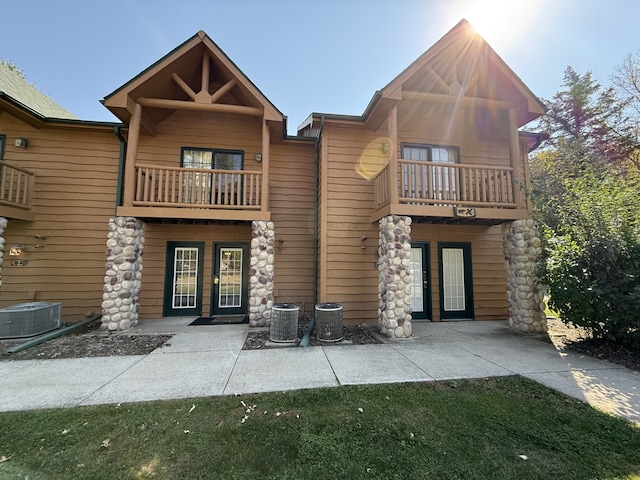 back of house featuring central AC, french doors, and a balcony