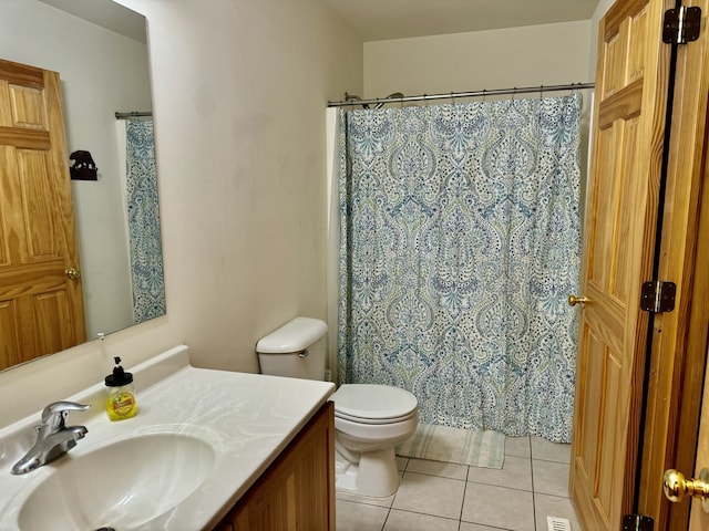 bathroom featuring vanity, tile patterned flooring, toilet, and curtained shower