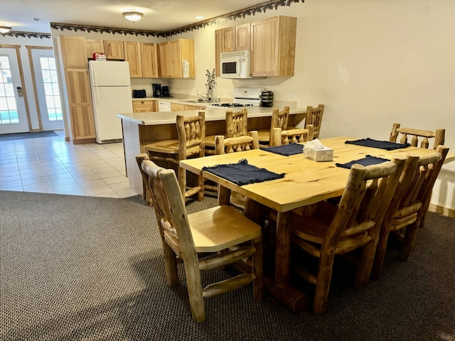 tiled dining area featuring sink