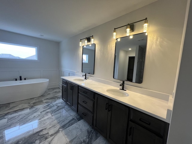 8673 High Stone Way, Frankfort, IL 60423 - bathroom with a freestanding bath, wainscoting, marble finish floor, and a decorative wall