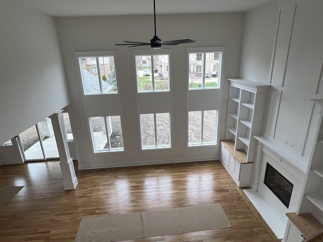 8673 High Stone Way, Frankfort, IL 60423 - unfurnished living room with a ceiling fan, a high end fireplace, built in features, wood finished floors, and stairway