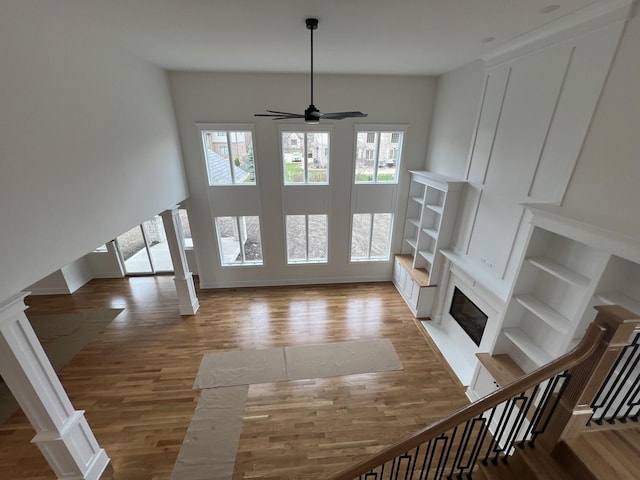 8673 High Stone Way, Frankfort, IL 60423 - unfurnished living room with a premium fireplace, ceiling fan, wood finished floors, and stairway