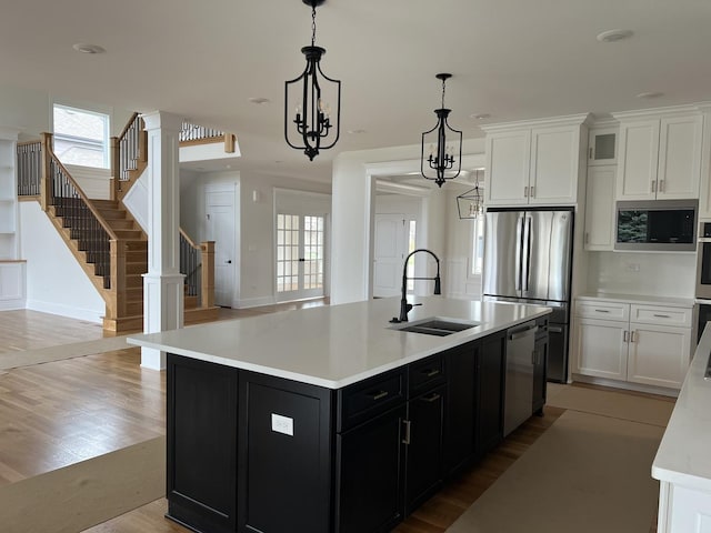 8673 High Stone Way, Frankfort, IL 60423 - kitchen featuring a spacious island, white cabinetry, appliances with stainless steel finishes, and a chandelier