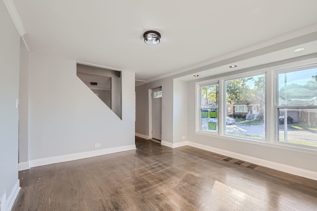 unfurnished room featuring ornamental molding and dark hardwood / wood-style floors