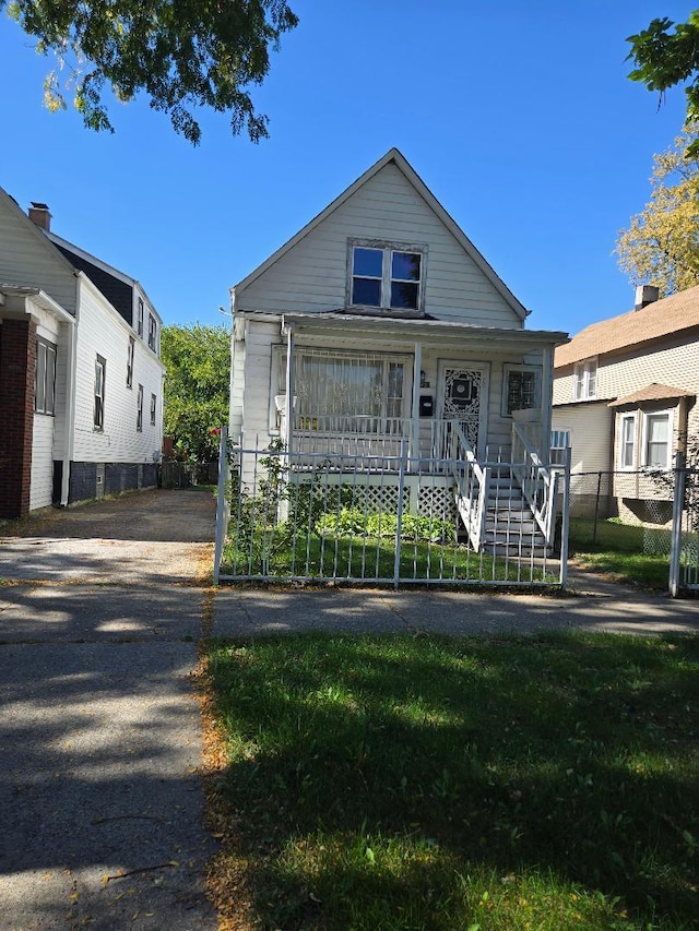 bungalow-style house featuring a front lawn