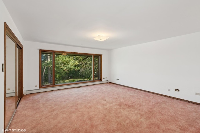 unfurnished bedroom featuring baseboard heating and light colored carpet