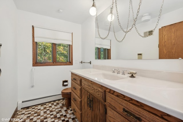 bathroom with vanity, toilet, and baseboard heating