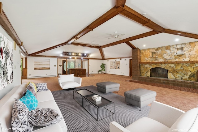 living room with carpet, lofted ceiling with beams, a stone fireplace, and ceiling fan