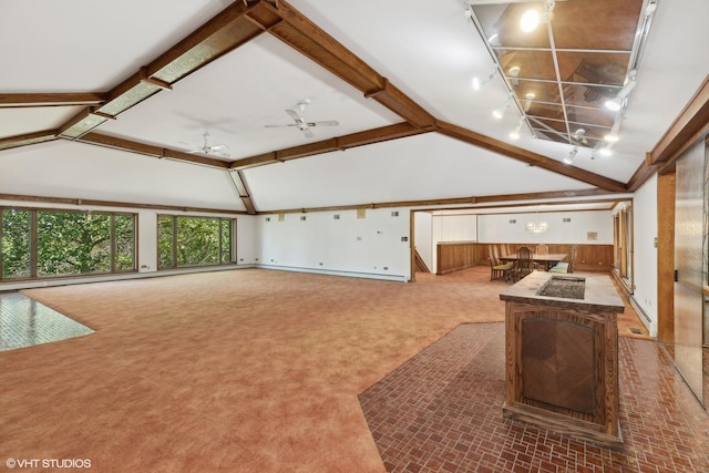 interior space with carpet, ceiling fan, wood walls, and lofted ceiling