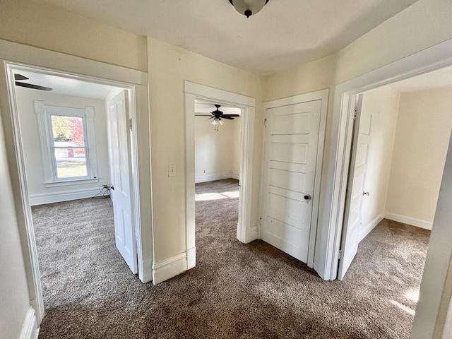 hallway featuring dark carpet