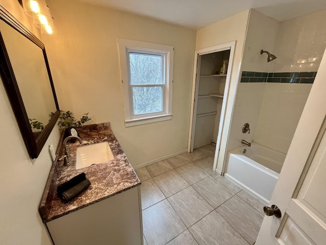 bathroom with vanity and tiled shower / bath