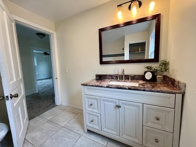 bathroom with tile patterned floors, ceiling fan, and vanity