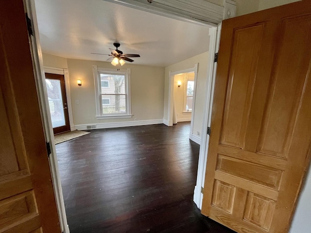 interior space with dark hardwood / wood-style floors and ceiling fan