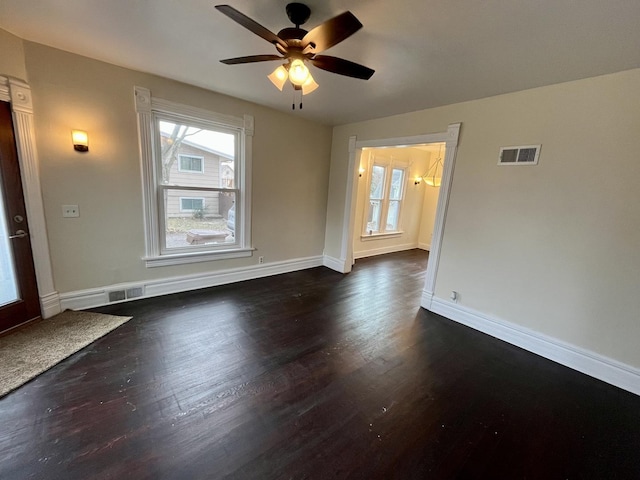 empty room featuring ceiling fan and dark hardwood / wood-style floors