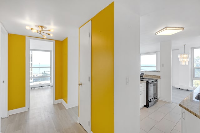 corridor with light hardwood / wood-style floors