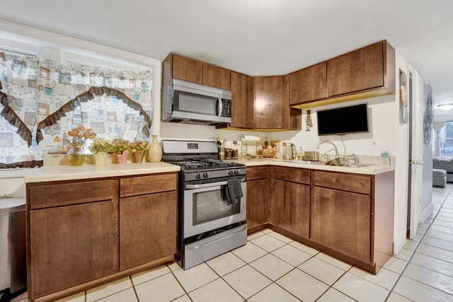 kitchen with light tile patterned flooring and appliances with stainless steel finishes