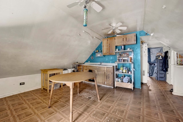 kitchen with ceiling fan, parquet floors, sink, and vaulted ceiling