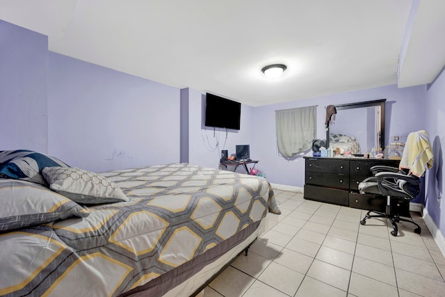 bedroom with light tile patterned floors