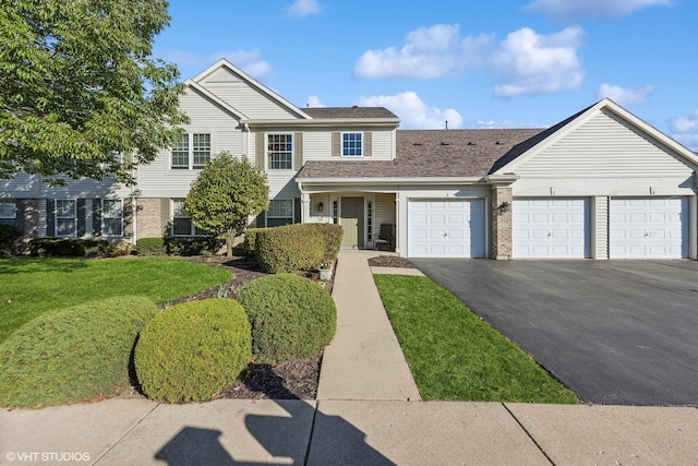 view of front of property featuring a garage and a front lawn