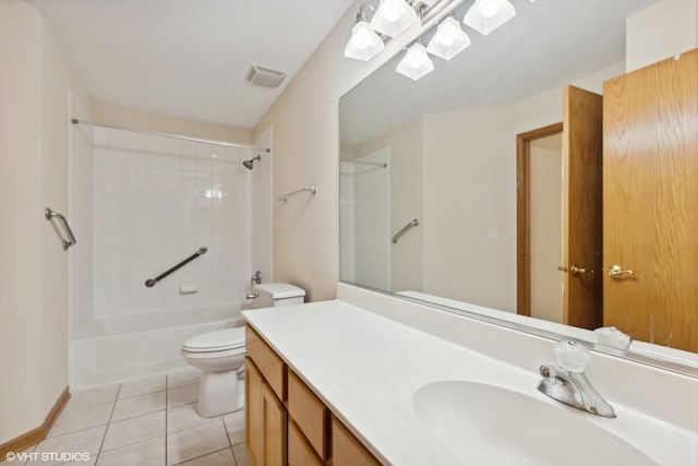 full bathroom featuring vanity, tile patterned flooring, toilet, and tiled shower / bath combo