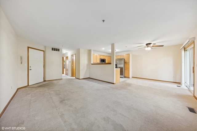 unfurnished living room with ceiling fan and light colored carpet