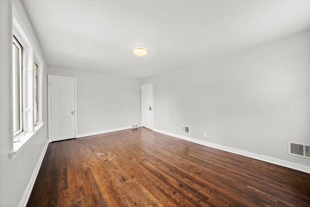 spare room with dark wood-type flooring