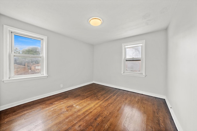 empty room with hardwood / wood-style floors