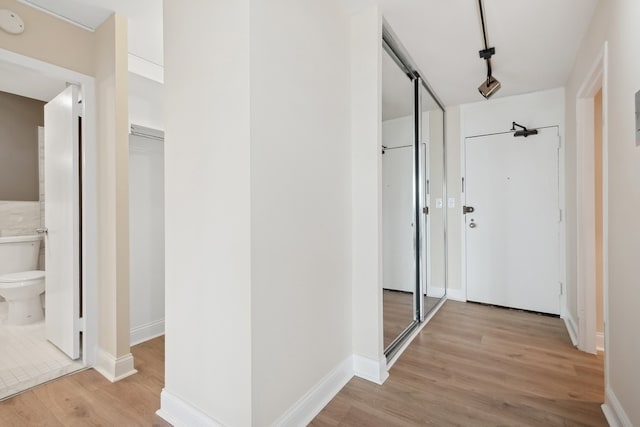 hall with light hardwood / wood-style flooring