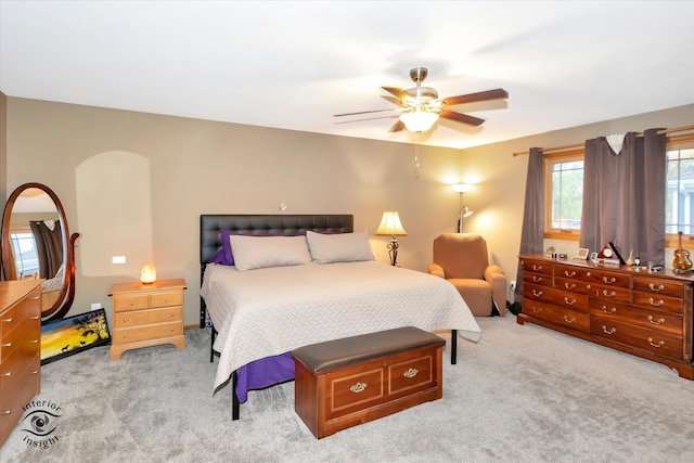 bedroom with light carpet and ceiling fan