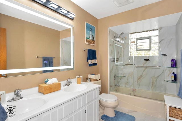 full bathroom featuring vanity, tiled shower / bath combo, toilet, and tile patterned flooring