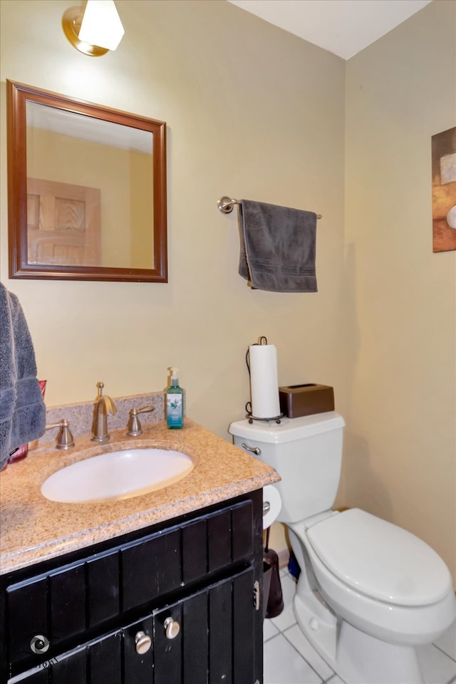 bathroom featuring vanity, toilet, and tile patterned floors