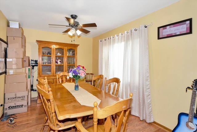 dining area with light hardwood / wood-style floors and ceiling fan