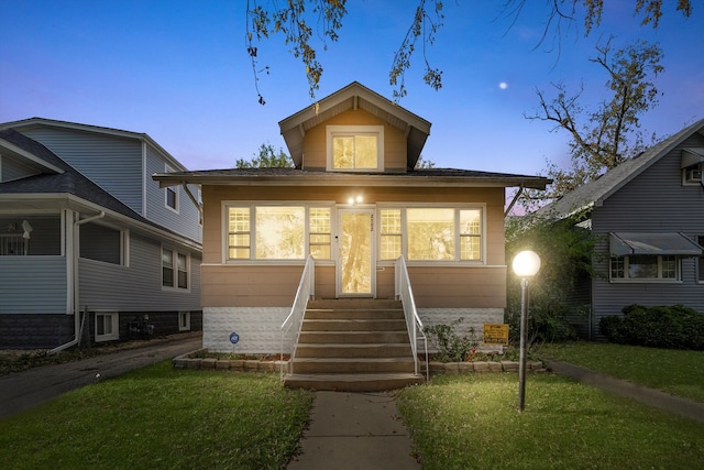 bungalow-style house featuring a yard