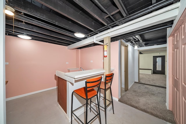 basement featuring indoor bar