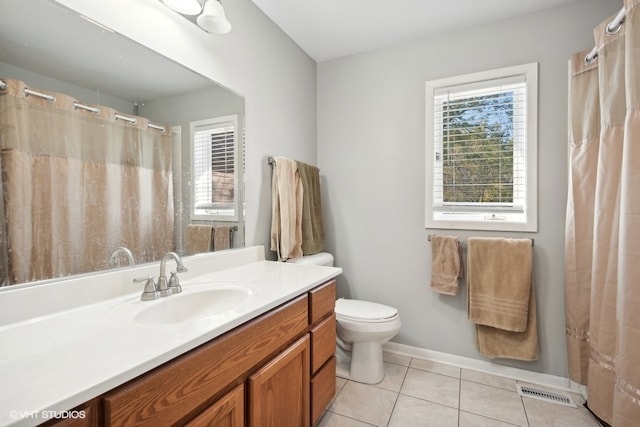 bathroom featuring vanity, toilet, and tile patterned flooring