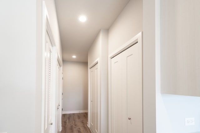 hallway with hardwood / wood-style flooring