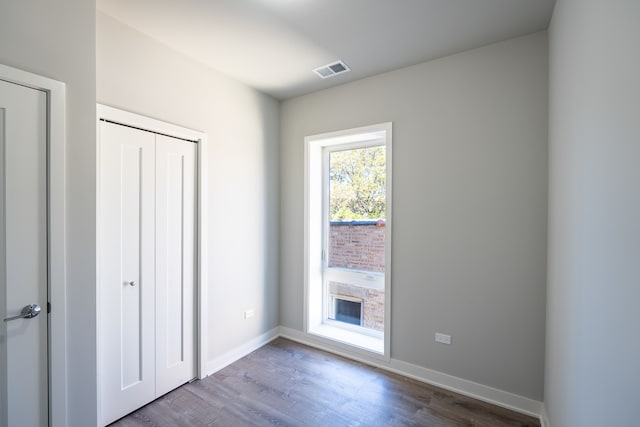 unfurnished bedroom with hardwood / wood-style flooring