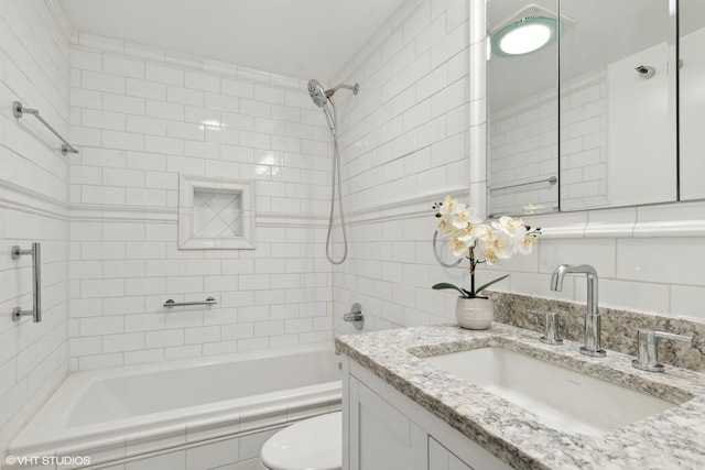 full bathroom with toilet, vanity, and tiled shower / bath