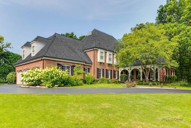 view of front of property with a garage and a front lawn