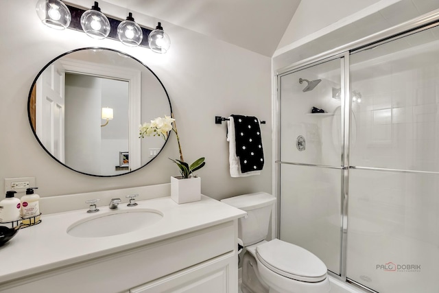 bathroom with vaulted ceiling, toilet, vanity, and walk in shower