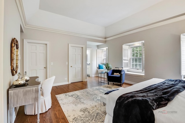 bedroom featuring dark hardwood / wood-style flooring and a tray ceiling