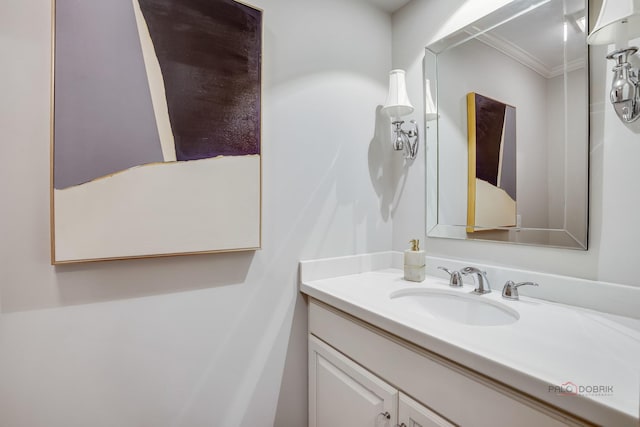 bathroom featuring crown molding and vanity