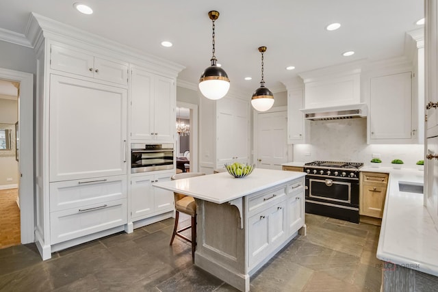 kitchen with pendant lighting, oven, white cabinets, double oven range, and ornamental molding