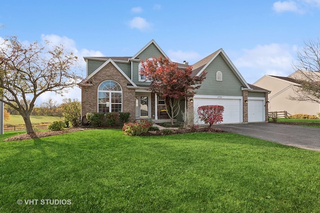 view of property with a garage and a front yard