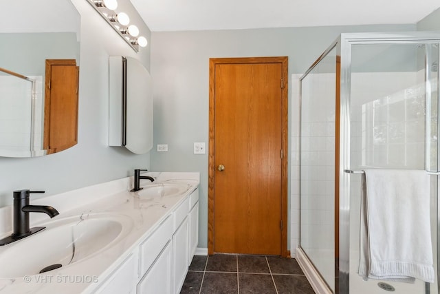 bathroom with tile patterned flooring, vanity, and a shower with shower door