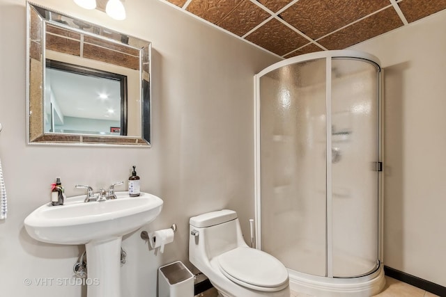 bathroom featuring toilet and an enclosed shower