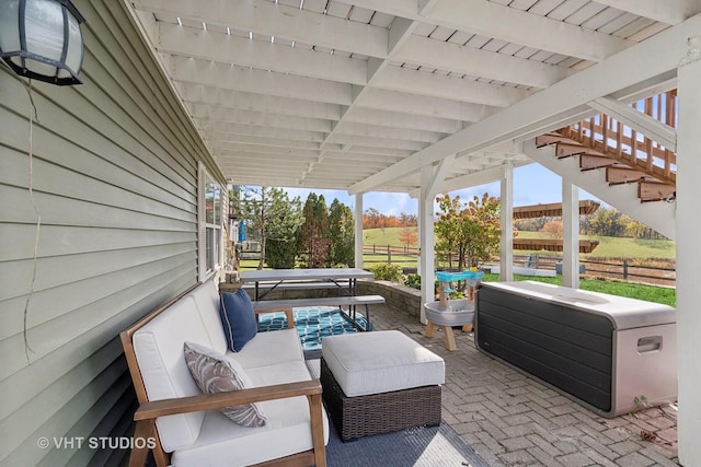 view of patio featuring an outdoor living space and a hot tub