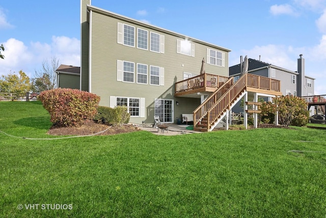 rear view of property with a yard, a deck, and a patio area